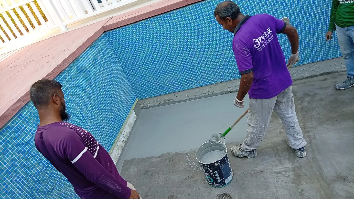 Pool waterproofing: Cementitious coating inside a tiled pool.