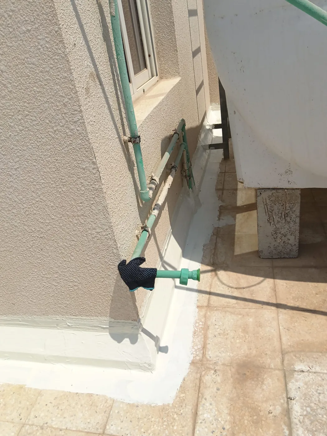 Detailing: Upstands and pipe penetrations treated first.